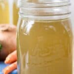 Chicken broth in a glass canning jar.