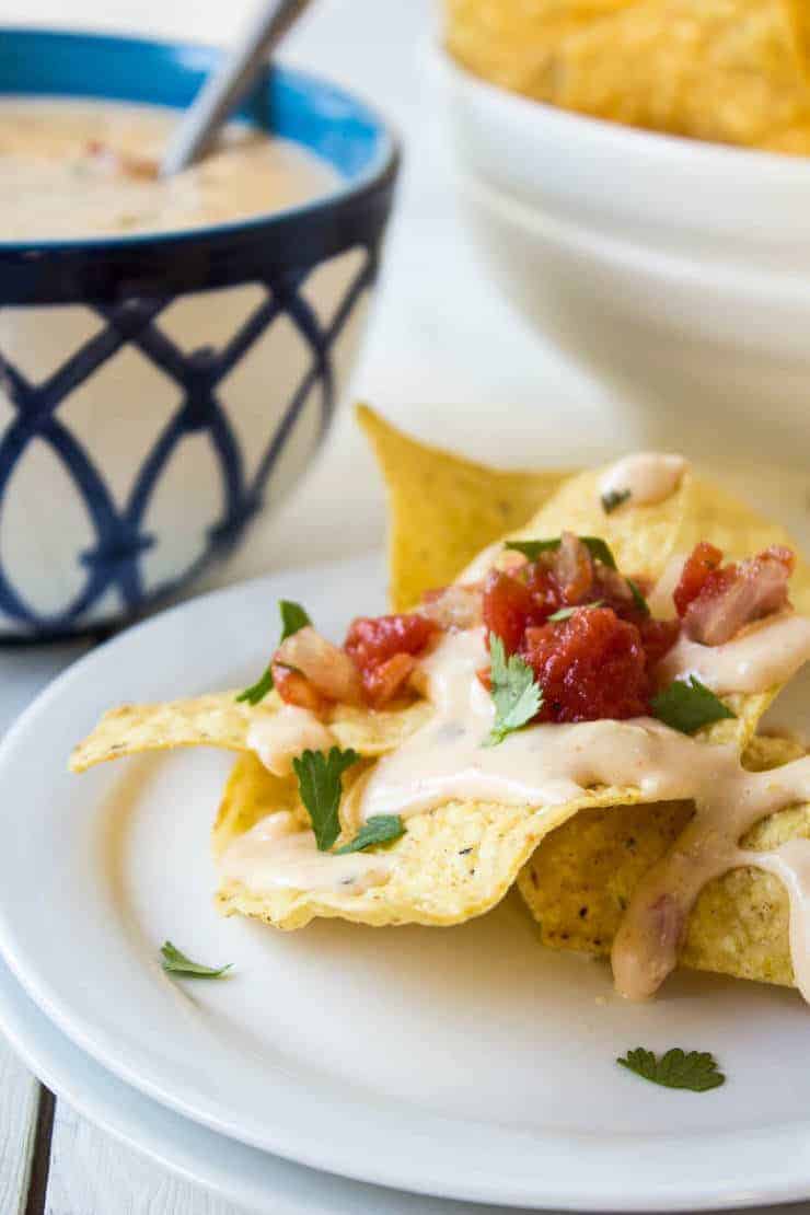 Cheese sauce poured on top of tortilla chips.