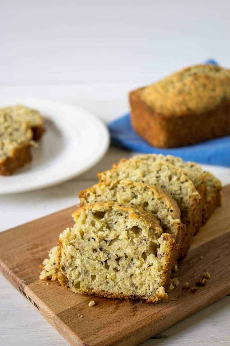 Sliced banana bread on a wooden cutting board.