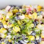 A bowl filled with black beans and corn with lime zest.