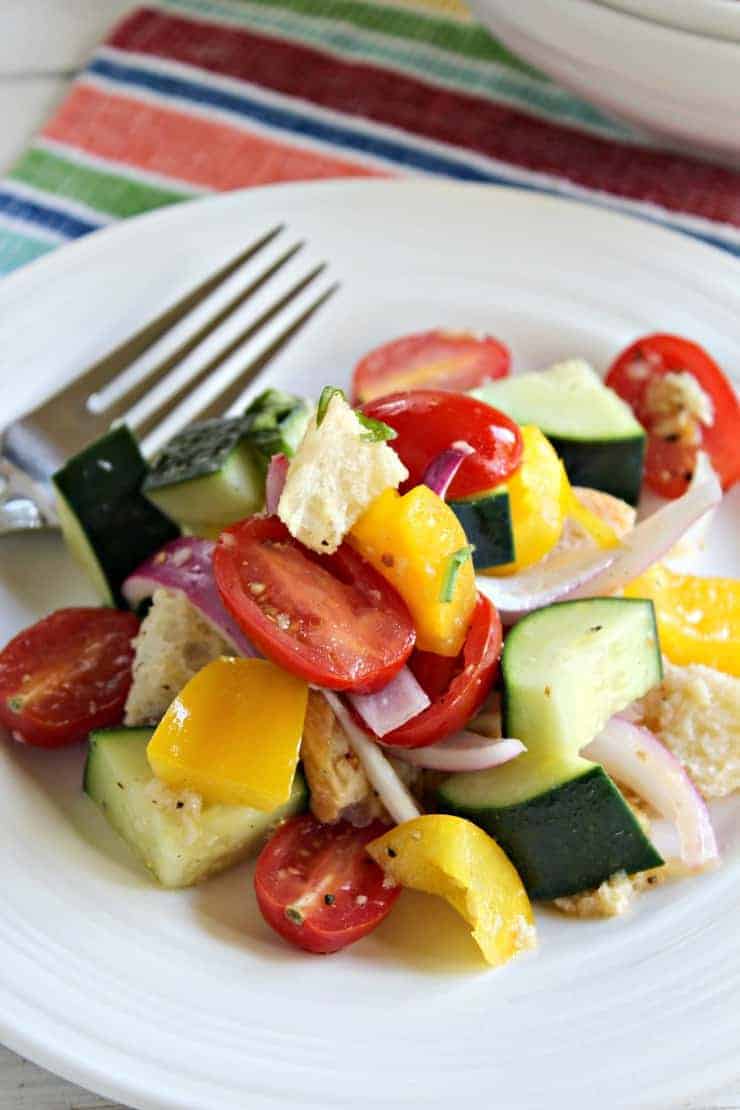Panzanella Salad on a white plate with a fork.