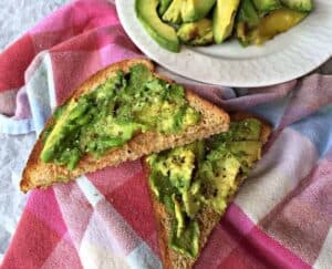 Smashed avocadoes on pieces of toast.