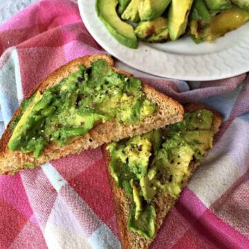 Smashed avocadoes on pieces of toast.