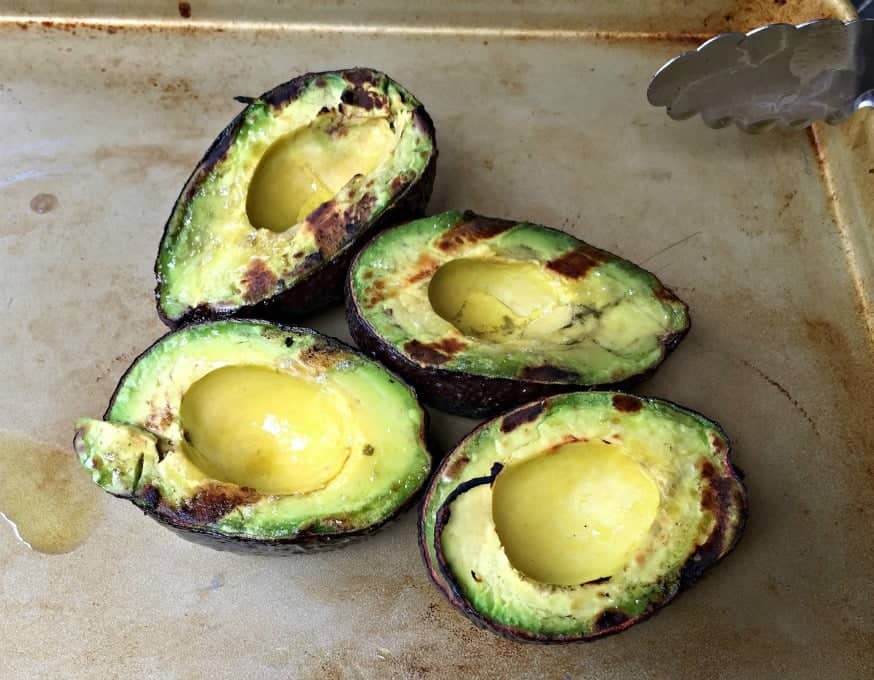 Grilled Avocados on a baking sheet. 