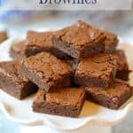 A cake stand topped with brownies.