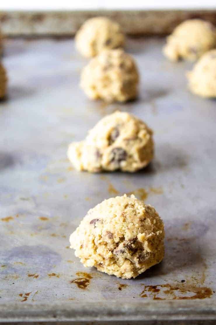 Cookie dough balls on a baking sheet.