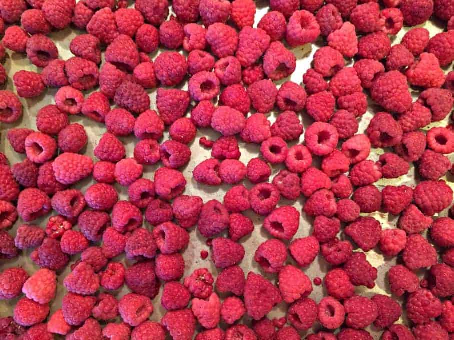 Frozen Raspberries on a baking sheet.