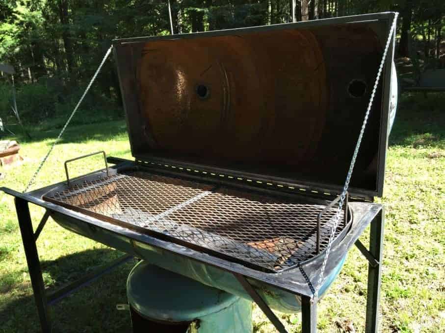 A large grill with the lid opened.