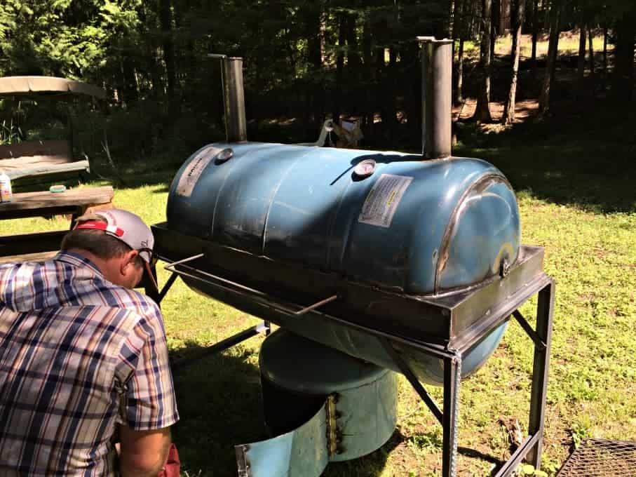 Homemade Smoker and Grill outside in a grassy area.