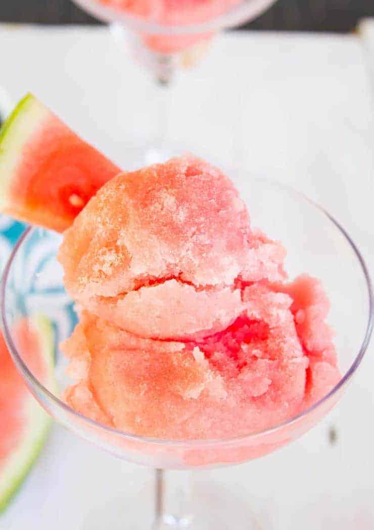 Scoops of watermelon sorbet in a margarita glass. 