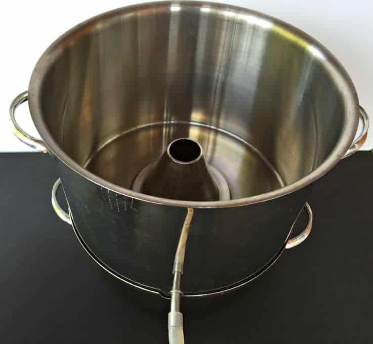 The middle layer of a steam juicer has a funnel in the center.