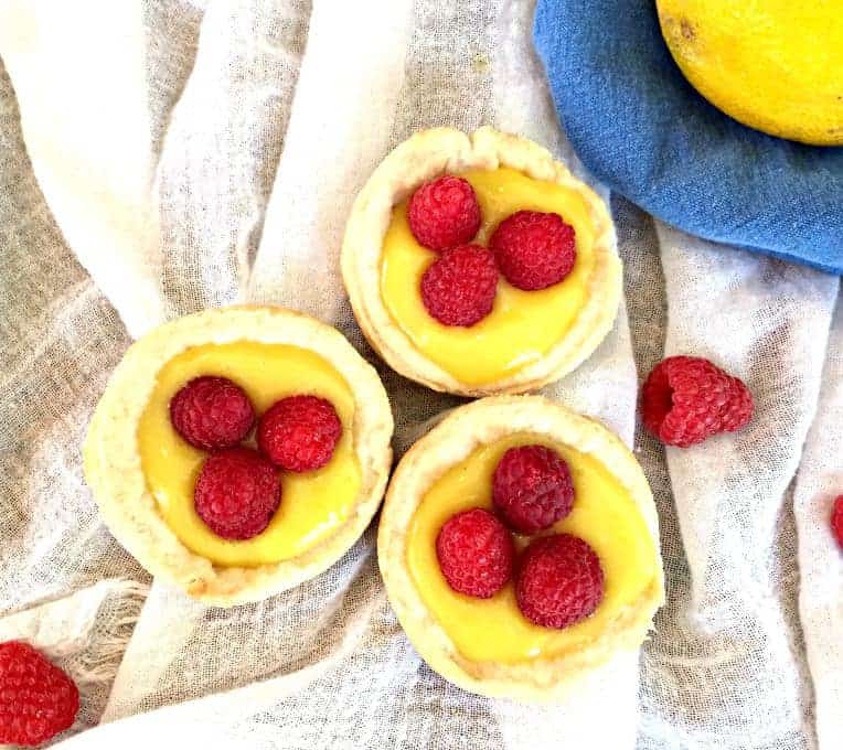 Mini cupcake sized tarts filled with lemon curd and topped with raspberries. 