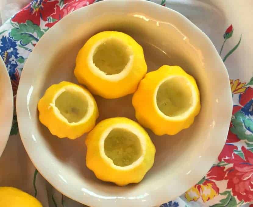 Hollowed out pattypan squash in a casserole dish.