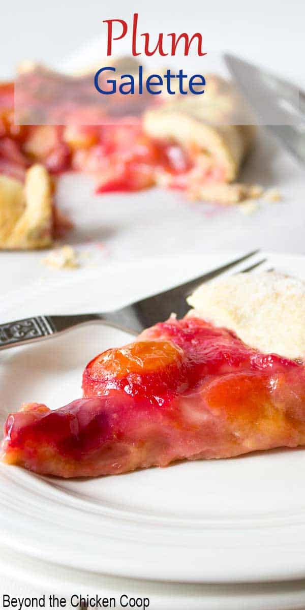 A slice of plum pie on a white palte.