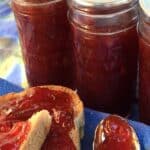 Plum jam spread on toast and on a spoon.