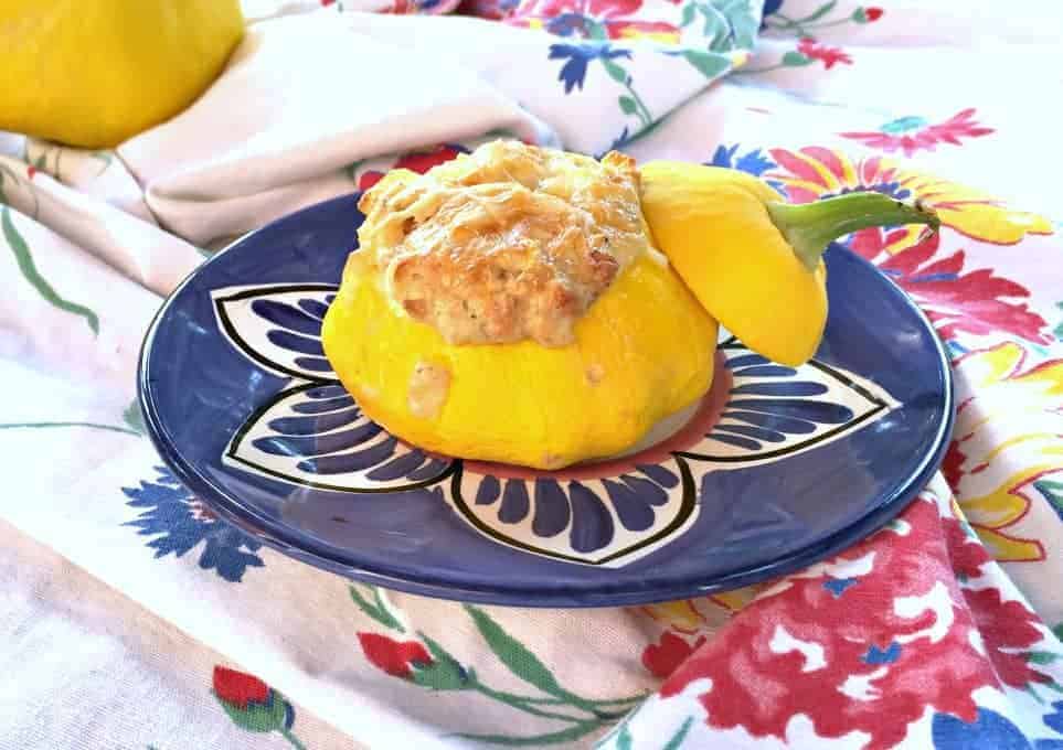 Stuffed pattypan squash on a blue patterned plate.