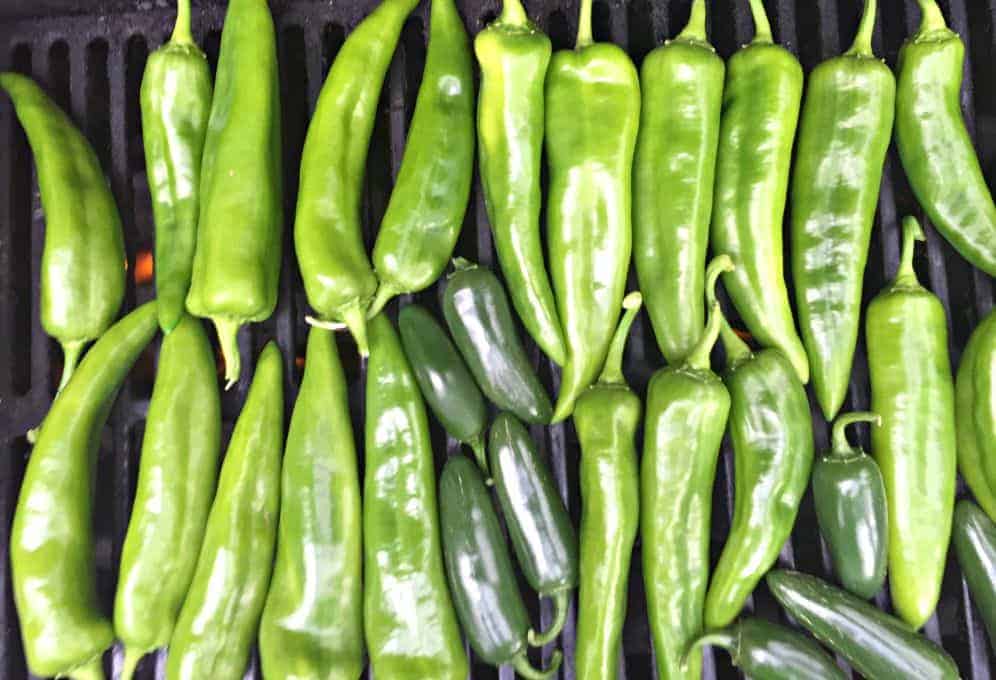 A BBQ grill filled with chili peppers.