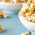 Homemade caramel popcorn served in a white bowl.