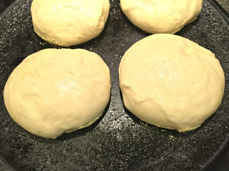 Bread dough cooking on a cast iron skillet.