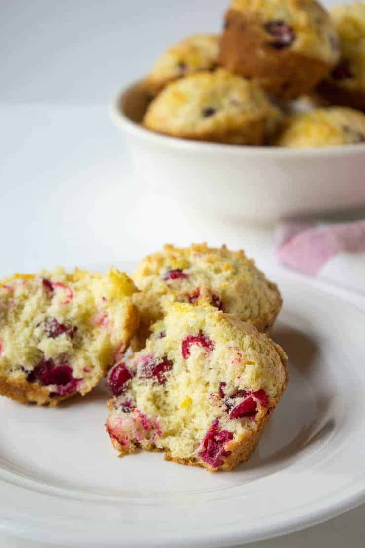 Muffins with red berries on a small white plate. 