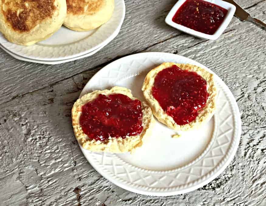 Homemade raspberry jam on a toasted muffin.