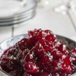 A china bowl filled with cranberry sauce.