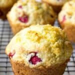 Cranberry muffins arranged on a baking rack.