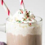 Mug filled with hot cocoa and topped with whipped cream.