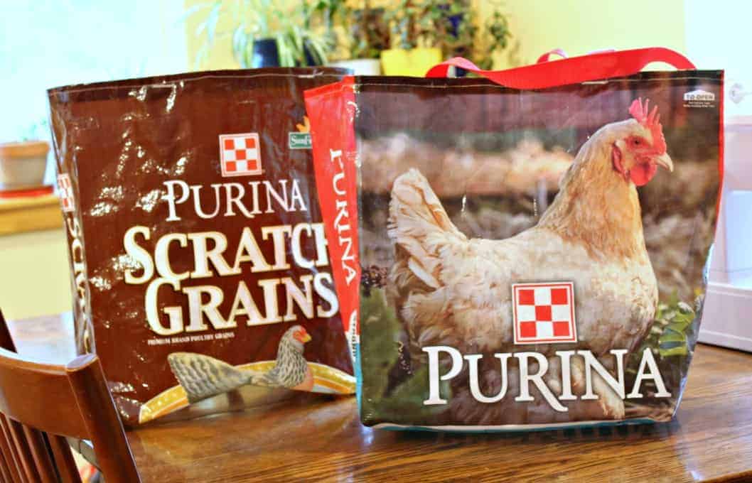 Tote bags made from chicken feed bags sitting on a kitchen table.