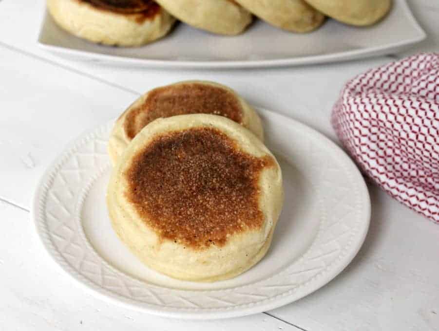 English Muffins overlapping each other on a plate.