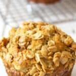 A muffin topped with crumbly oatmeal.