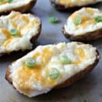Double stuffed baked potatoes topped with melted cheese and green onions.