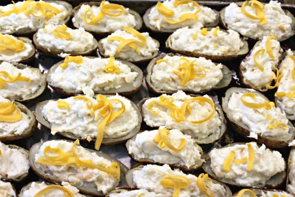 A baking sheet full of stuffed potatoes.