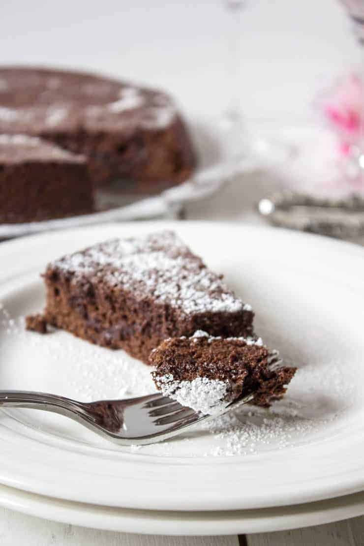 A fork with a bite of chocolate cake on the end of the fork.