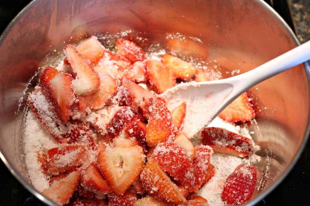 Cut strawberries and sugar in a large pot.