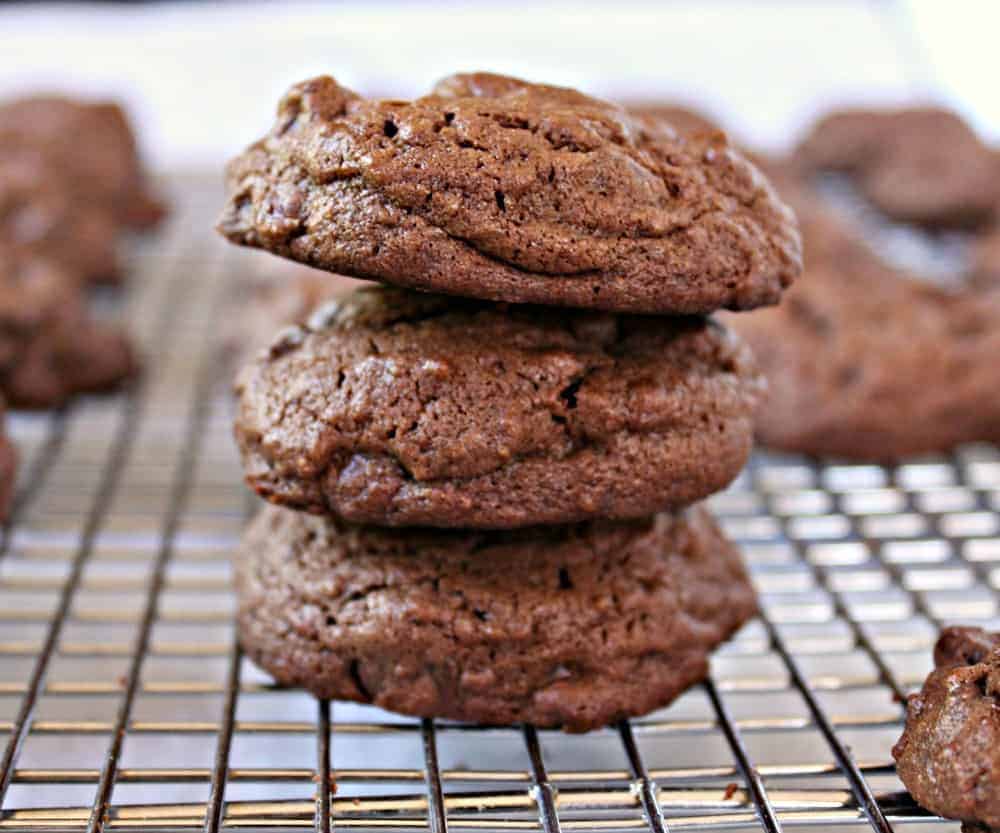 A stack of chocolate cookies on a baking rack.
