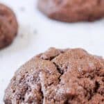 A chocolate cookie filled with chocolate chips.