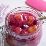 A glass jar filled with cherry pie filling.