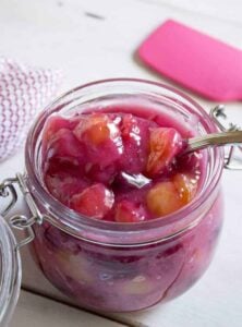 A glass jar filled with cherry pie filling.
