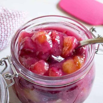 Cherry pie filling in a glass crock.