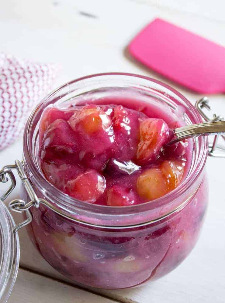 Cherry pie filling in a glass crock.