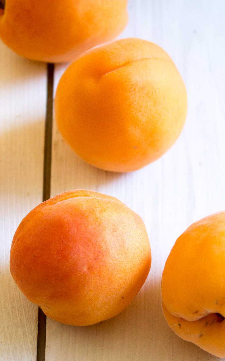 Fresh Apricots on a white board.