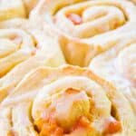 A glass baking dish filled with sweet rolls with apricots.