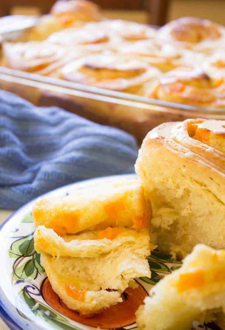 Sweet rolls filled with apricots on a plate.