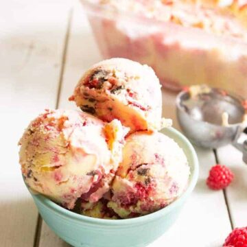 Old Fashioned churned ice cream with swirls of raspberry sauce and chunks of chocolate. beyondthechickencoop.com