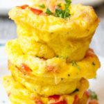 A stack of egg muffins filled with bell peppers and ham.