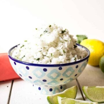 A blue and white patterned bowl filled with rice.