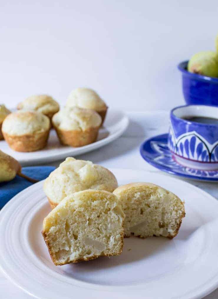 A muffin cut in half on a plate. 