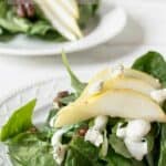 Fresh salad topped with blue cheese and slice pears.