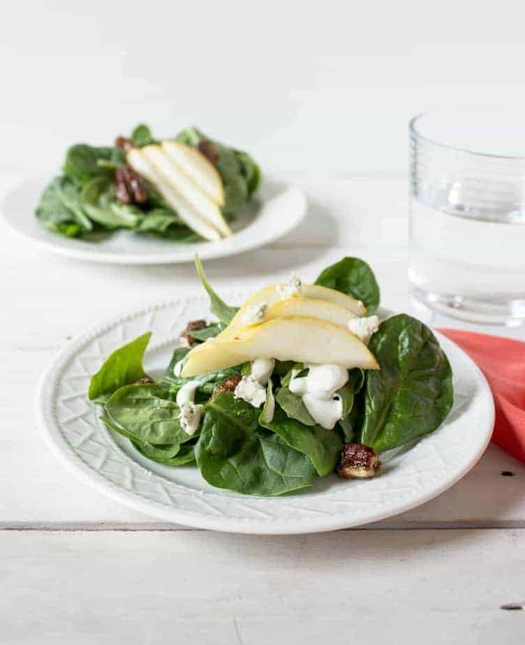 Spinach leaves topped with fresh pear slices.